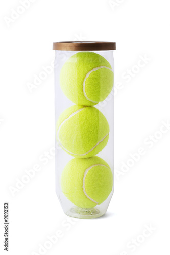 New tennis balls in plastic container on white background