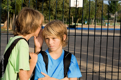 children whispering secrets, chatting , gossiping or threatening