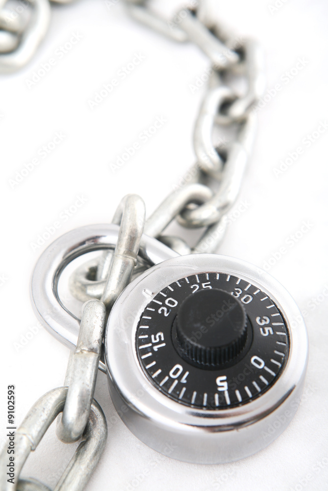 A combination lock an a silver chain shot with shallow DOF A combination lock an a silver chain shot with shallow DOF