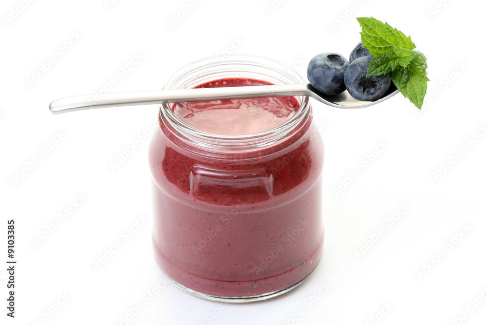jar of delicious yogurt and some fresh fruits isolated on white