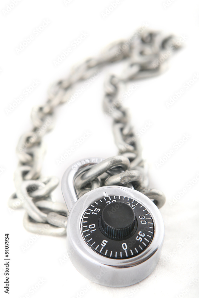 A combination lock an a silver chain shot with shallow DOF A combination lock an a silver chain shot with shallow DOF