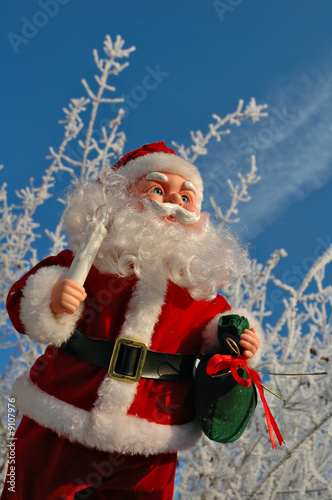 Toy Santa Claus on a background of a winter garden