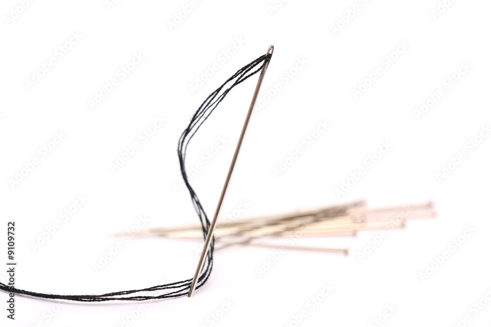 A needle with thread over white background. A needle with thread over white background.