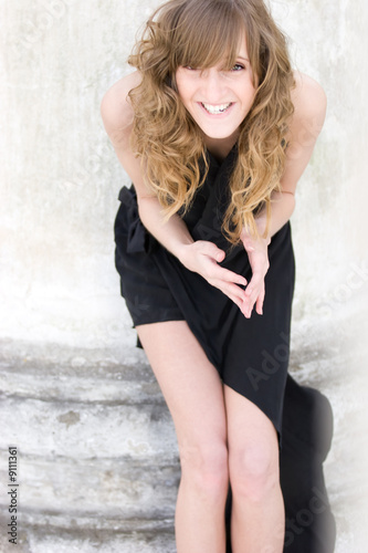 Young fashion model  posing in sexy black dress