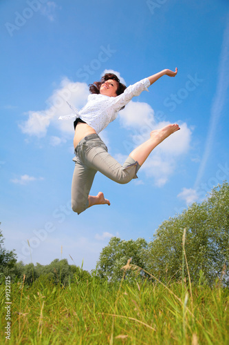 beauty woman jumps on grass
