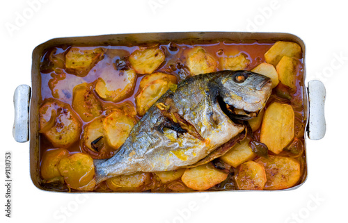 Photos gilthead bream fish roasted in a tray