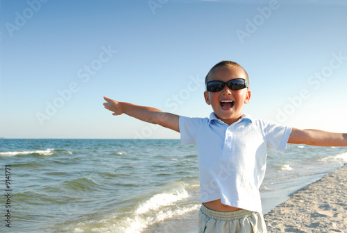 Happy little boy playing  on the beach. © Valua Vitaly