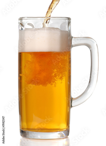 Beer mug isolated on white. Pouring beer in it.