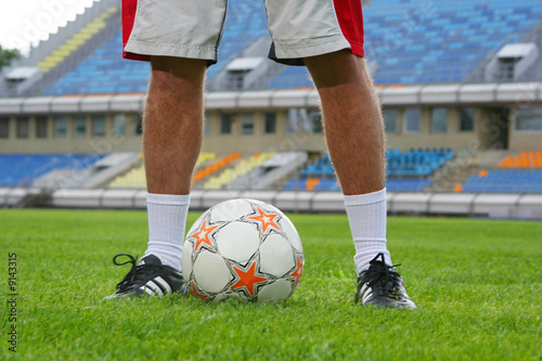 young guy playing football on stadium