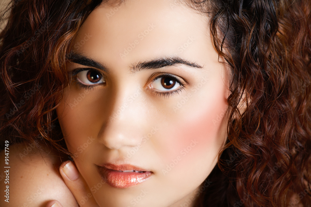 young woman with brown curly hair and golden fashion young woman with brown curly hair and golden fashion