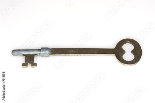 Macro shot of an antique key on white background © Claude Beaubien