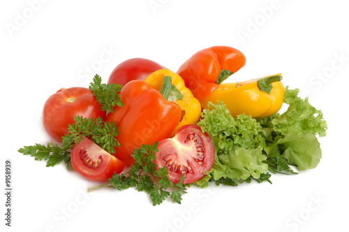 Orange and yellow bell peppers, tomatos, lettuce and parsley