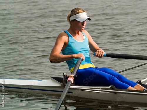 Εκτύπωση καμβά Sporty young lady rowing in boat on water