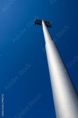 A football stadium floodlights on blue sky