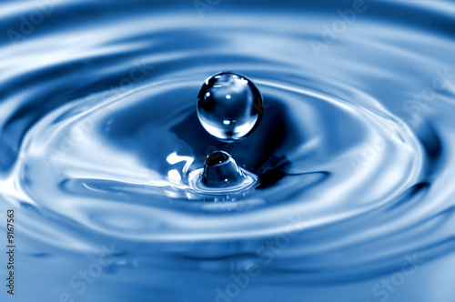 An extreme closeup of a sphercial drop of water.