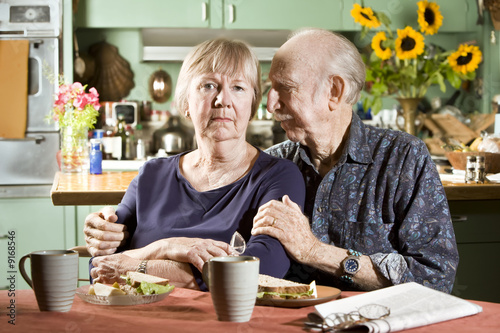 Portrait of Worried Senior Couple in their Dining Room photo
