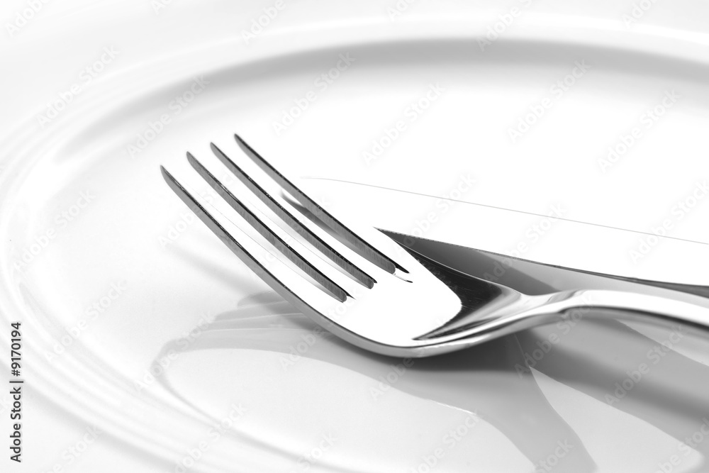fork and knife on a plate close-up shot fork and knife on a plate close-up shot