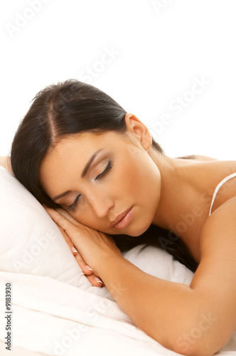 Portrait of 20-25 years old beautiful woman on white bed