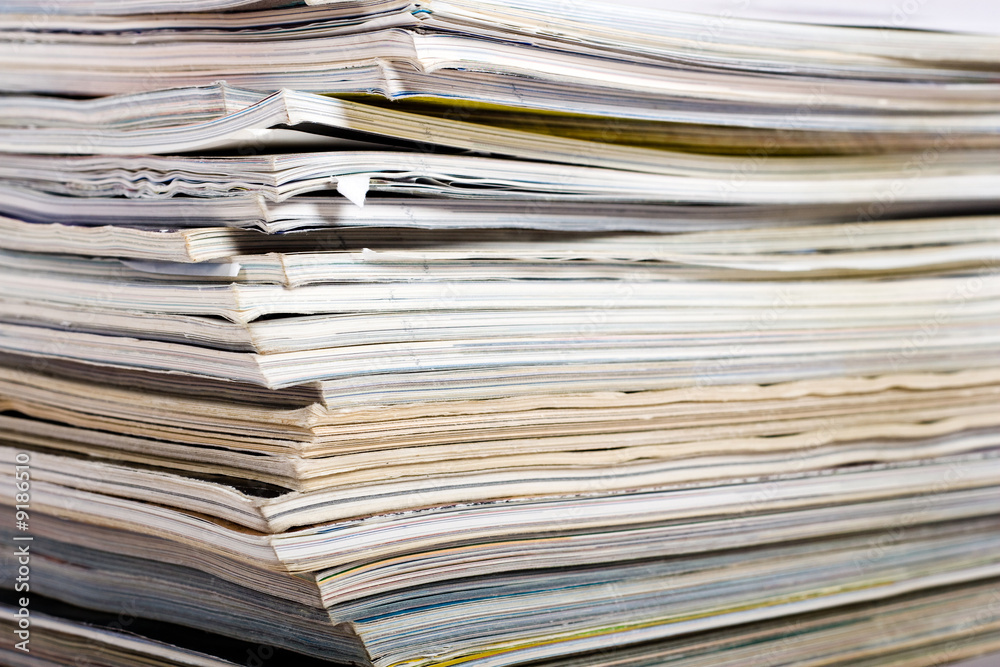 Stack of newspaper on neutral background close up Stack of newspaper on neutral background close up