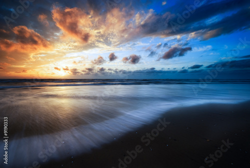 beautiful sunset and waves on the beach © Eric Gevaert
