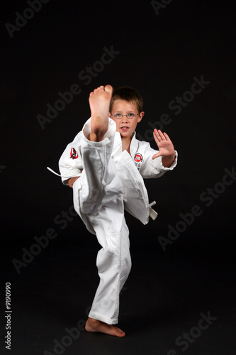 boy demonstrating traditional karate front snap kick