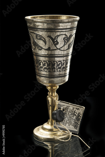 Ancient winecup on black background