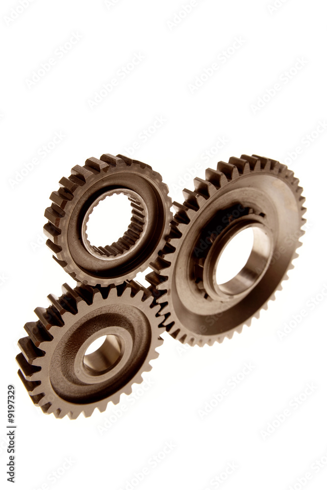 Three gears meshing together over white Three gears meshing together over white
