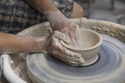 A potter works on a bowl at the Laguna Sawdust Art Festival.