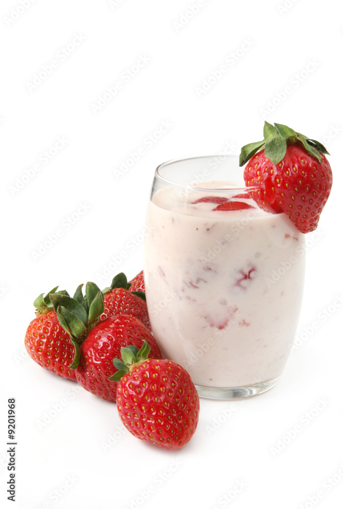 Glass of strawberry yoghurt, surrounded by strawberries. Glass of strawberry yoghurt, surrounded by strawberries.