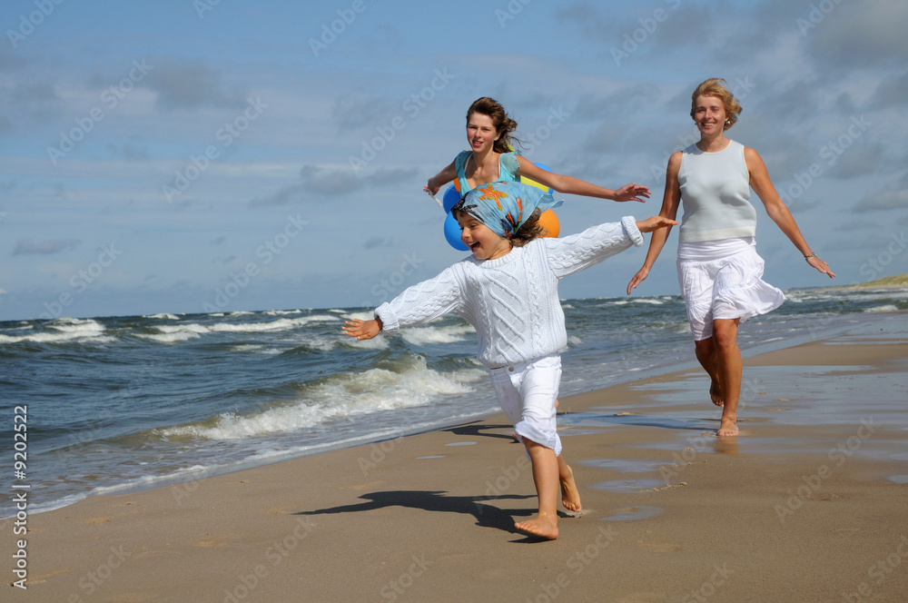 Happy family playing on the beach Happy family playing on the beach