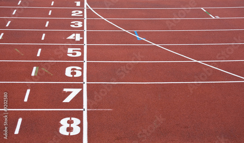 red running tracks with white start numbers at stadium