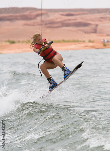 Pretty girl wakboarding with beautiful Lake Powell