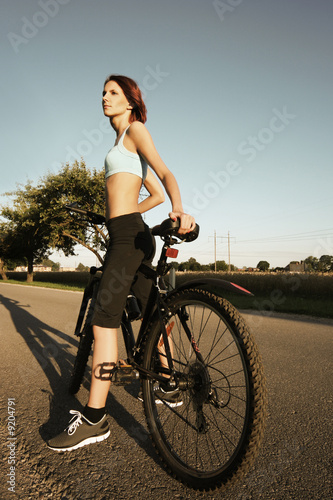 slim girl on bicycle outdoors