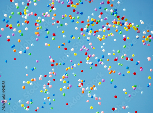 colored balloons flying up in the sky