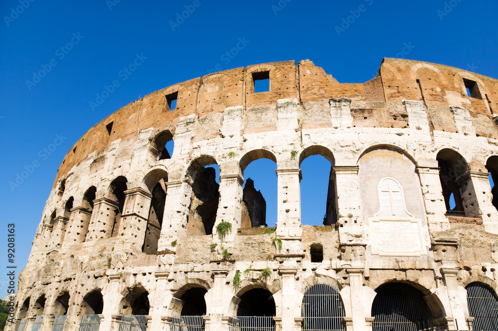 Coliseum in Rome Italy. On blue sky background.