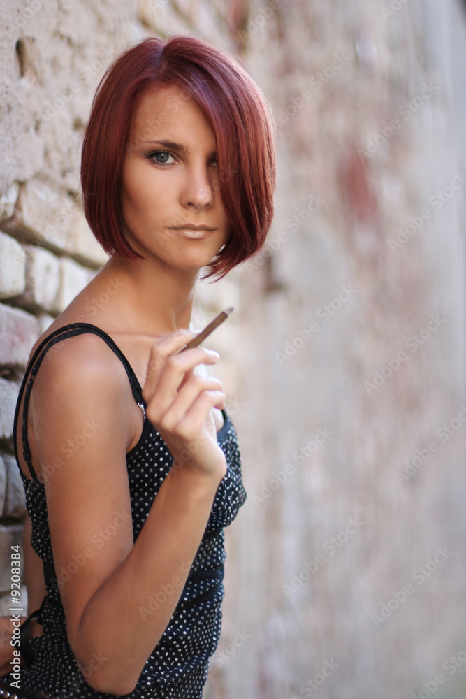Fototapeta premium sexy young girl near old wall