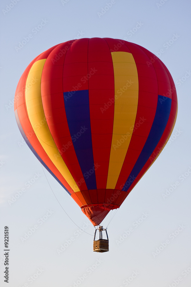 Fototapeta premium No one on board Colorful hot air balloon mid-air on a clear day