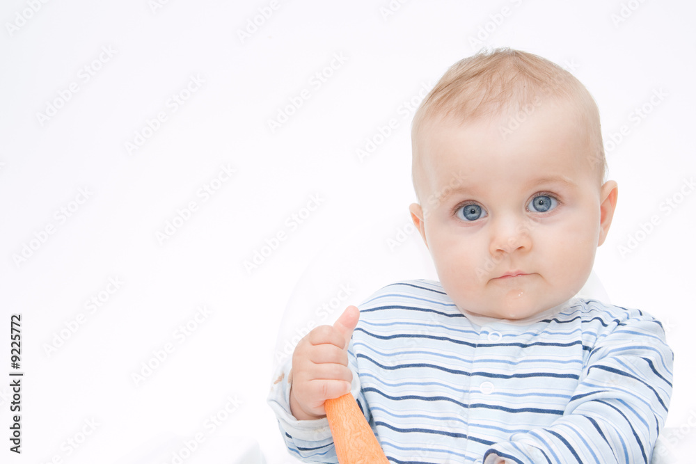 little, cute baby boy eating fresh carrot, on white little, cute baby boy eating fresh carrot, on white