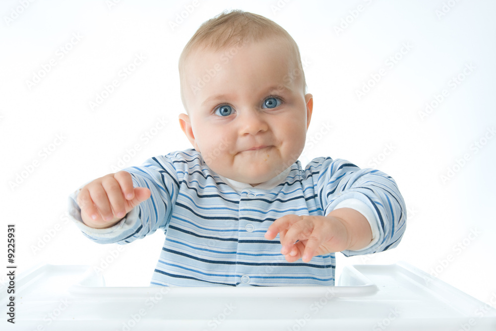 cute baby boy sitting in a high chair and making faces cute baby boy sitting in a high chair and making faces