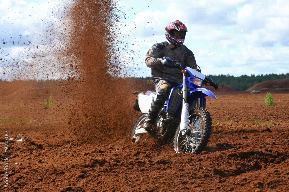 Fototapeta premium Off-road motorbike in extreme dirt. A lot of flying dirt.