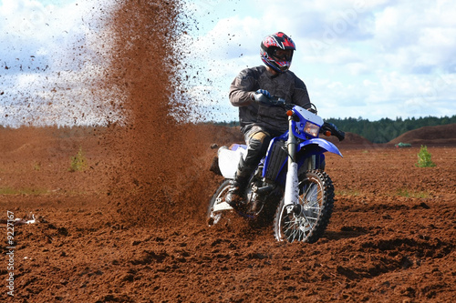 Off-road motorbike in extreme dirt. A lot of flying dirt.