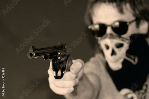 masked man with hand gun photo