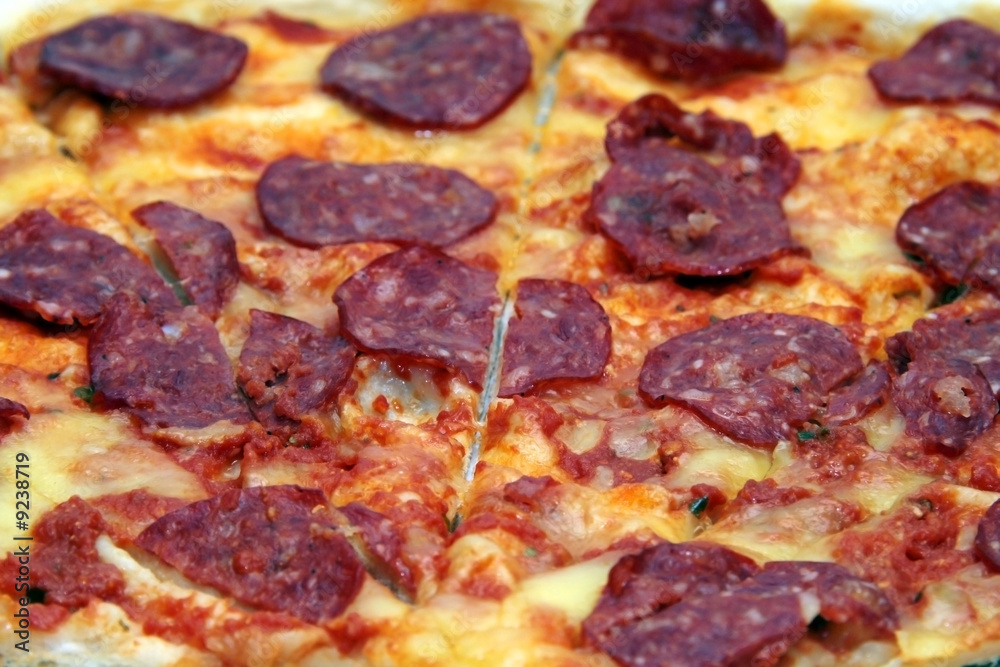 close up shot of a pepperoni flavored pizza. close up shot of a pepperoni flavored pizza.