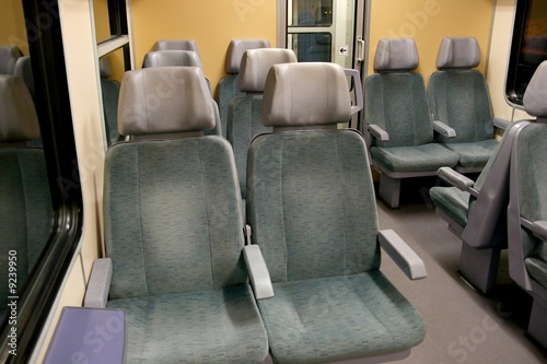Interior of a passenger train with empty seats