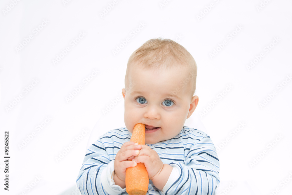 little, cute baby boy eating fresh carrot, on white little, cute baby boy eating fresh carrot, on white