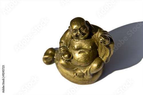 Golden Buddha holding an apple in the sun and having fun!