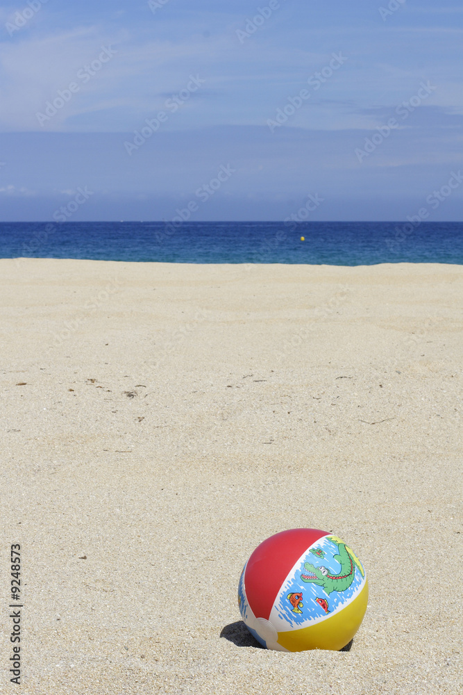 a beachball on empty sandy beach in Corsica a beachball on empty sandy beach in Corsica