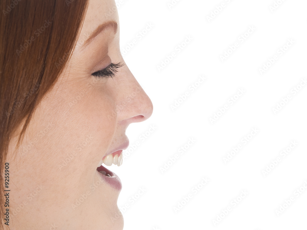 Obraz premium Isolated studio shot of a laughing businesswoman's profile