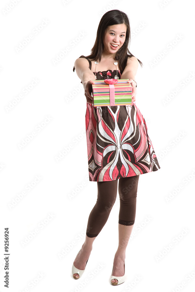 An isolated shot of a beautiful asian woman giving a gift box An isolated shot of a beautiful asian woman giving a gift box
