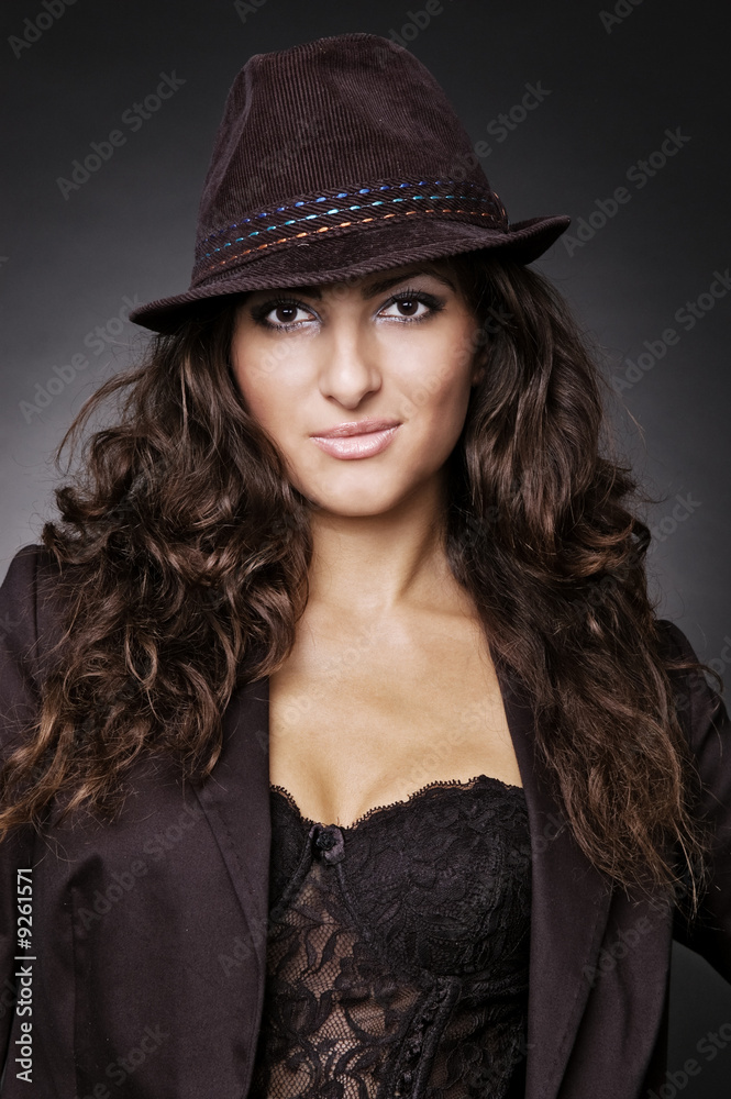smiley woman in hat over dark background smiley woman in hat over dark background